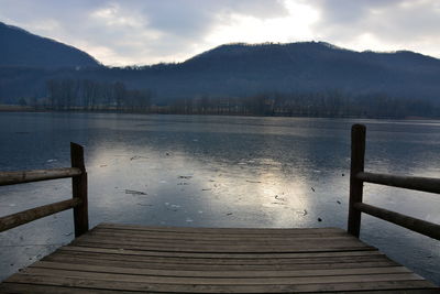 Pier over lake against sky