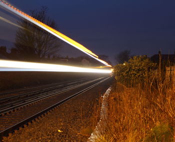Blurred motion of train on road at night