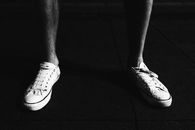 Legs in white sneakers