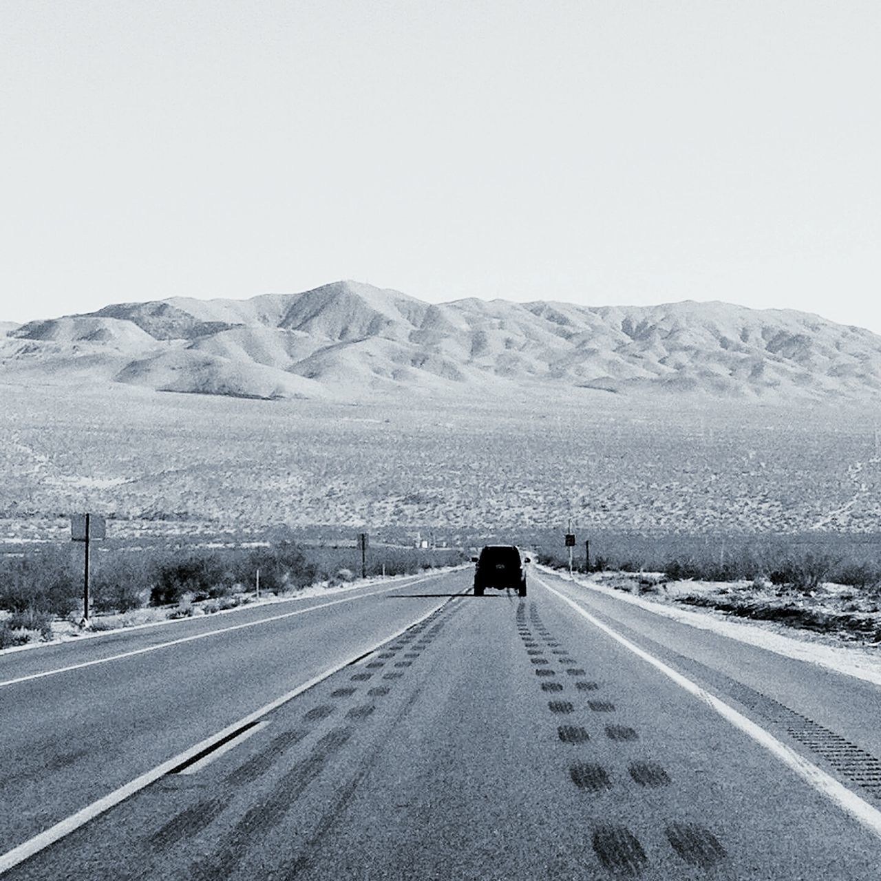 transportation, road, the way forward, mountain, road marking, country road, landscape, land vehicle, clear sky, mountain range, diminishing perspective, mode of transport, vanishing point, car, copy space, street, tranquil scene, sky, asphalt, non-urban scene