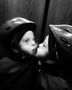Reflection of baby on mirror with helmet