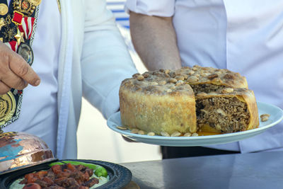 Midsection of man holding food