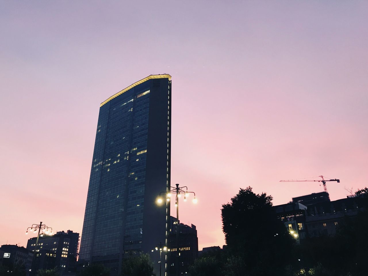 LOW ANGLE VIEW OF SKYSCRAPERS AGAINST SKY AT NIGHT