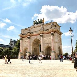 Tourists at historical building against sky