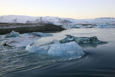 View of ice in lake against sky