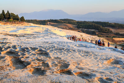 Group of people on land against sky