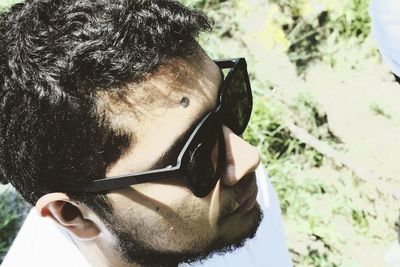 High angle view of young man wearing sunglasses while standing outdoors