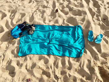 High angle view of towel on sand at beach