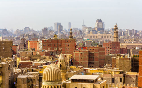 High angle view of buildings in city against clear sky