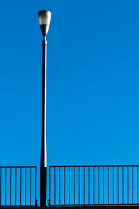 Low angle view of street light against blue sky