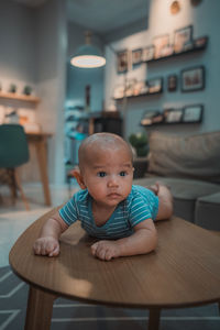 Portrait of boy sitting on table