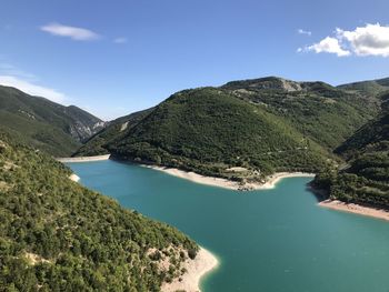 Scenic view of lake and mountains against sky