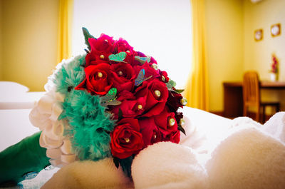 Close up of red rose bouquet on bed at home