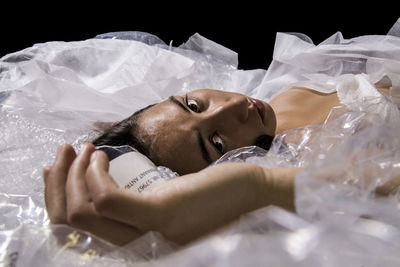 High angle view of woman swimming in a plastic sea