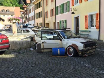 Cars parked on street in front of houses