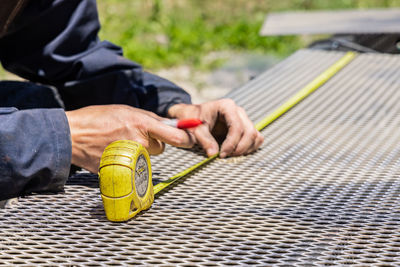 Close-up of man working with metal