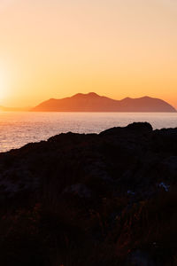 Scenic view of sea against clear sky during sunset