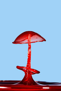 Close-up of red umbrella against clear blue sky