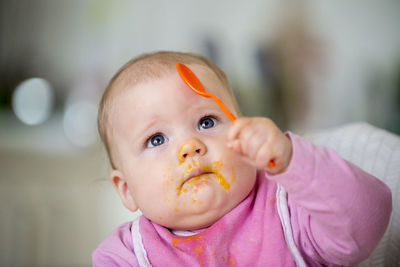 Close-up of cute baby girl at home