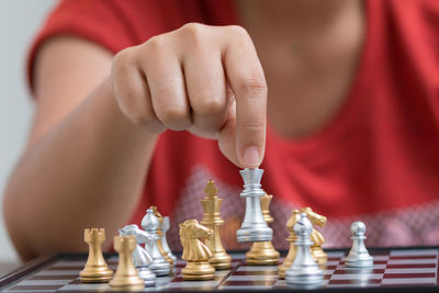 Midsection of woman playing chess