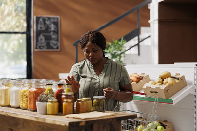 Side view of young man preparing food at home