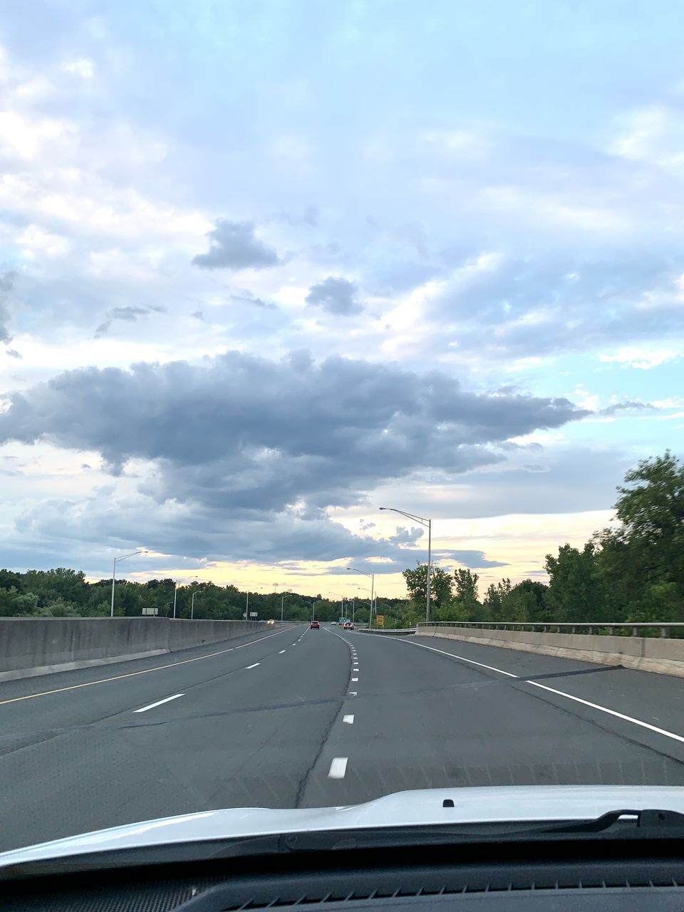 ROAD SEEN THROUGH WINDSHIELD OF CAR