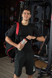 Portrait of young man holding camera