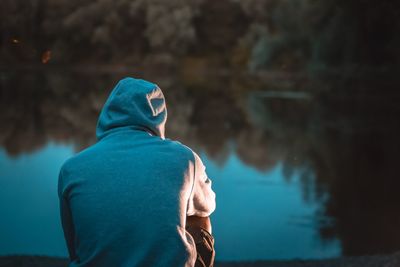 Rear view of man looking at water