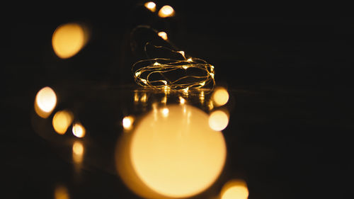 Close-up of illuminated lights on table