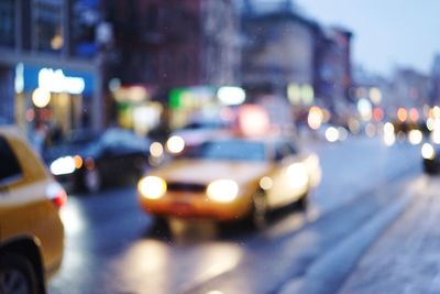 Defocused image of illuminated city at night