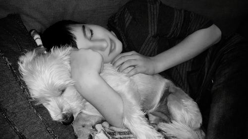 Close-up of young woman sleeping on bed at home