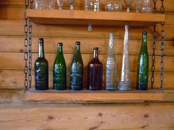 Full frame of wine bottles on wooden table