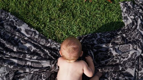 High angle view of shirtless baby boy