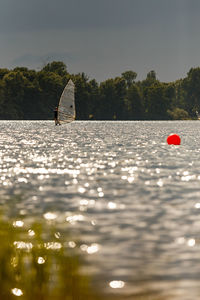 Person in sea against sky