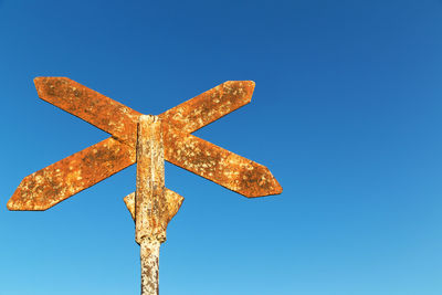 Low angle view of cross against blue sky