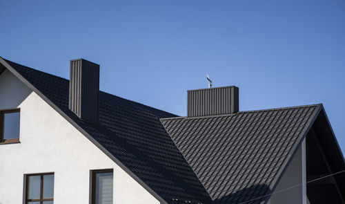 Low angle view of buildings against blue sky