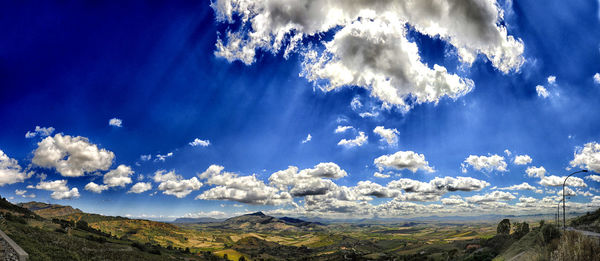 Scenic view of mountains against cloudy sky