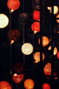 Close-up of illuminated lanterns hanging at night