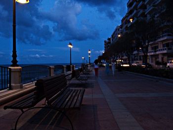 View of illuminated street light against cloudy sky