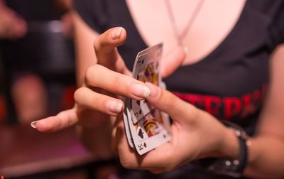 Midsection of woman playing poker