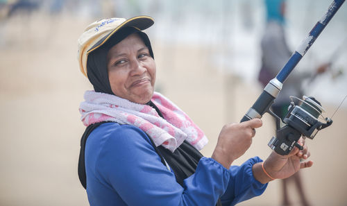 Woman fishing at beach