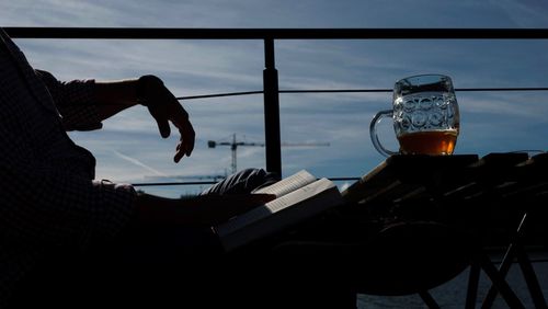 Midsection of man with arms raised against sky