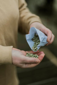 Midsection of man holding paper currency