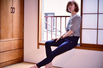 Side view of woman sitting on tatami mat