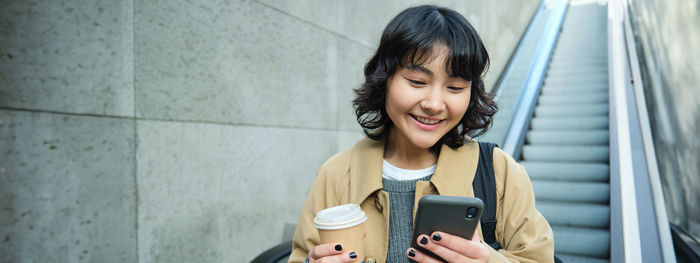 Portrait of young woman using mobile phone