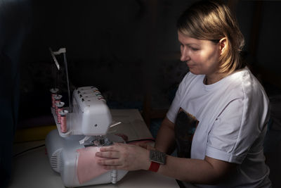 Boy using sewing machine