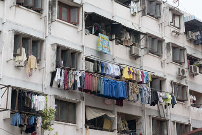 Low angle view of clothes drying against built structure