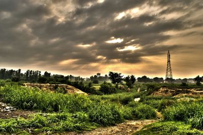 Scenic view of field against cloudy sky