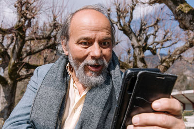 Portrait of a confident, handsome, mature man, pensioner, grandfather in the small town