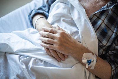 Midsection of man lying on bed